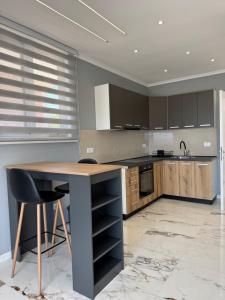 a kitchen with a wooden table and a counter at Paradise Luxury in Ulcinj