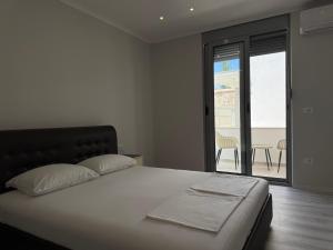 a bedroom with a bed and a view of a patio at Paradise Luxury in Ulcinj