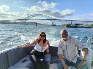 a man and a woman sitting on a boat on the water at Tour Full Day Taboga in Panama City