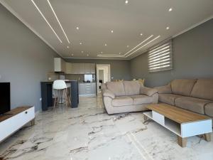 a living room with two couches and a kitchen at Paradise Luxury in Ulcinj +9 photos