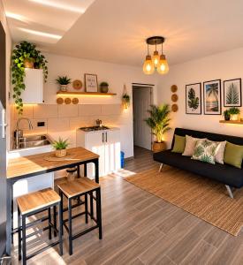 a kitchen and living room with a table and a couch at Xamanai Playa Rincón III in Las Galeras