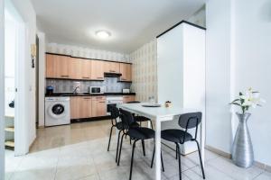 a kitchen with a table and chairs in a room at La Posadilla in Adeje