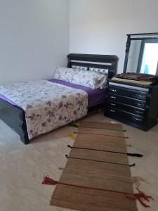 a bedroom with two beds and a rug on the floor at Modern Apartment with Pool & Sea View in Casablanca +26 photos