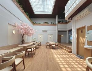 a waiting room with tables and chairs and a skylight at Tamashii Boutique Hotel in Bandung