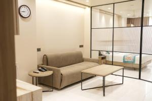 a living room with a couch and a bed at Vatsalya by Vrinda in Nāthdwāra