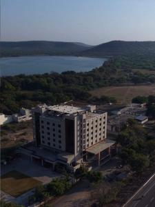 an aerial view of a building next to a lake at Centre Point Amravati in Amrāvati