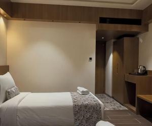 a hotel room with a bed in a room at Centre Point Amravati in Amrāvati