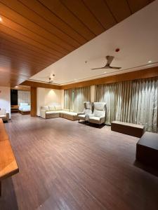 a large room with couches and chairs in a room at Centre Point Amravati in Amrāvati