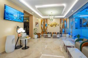 a living room with a lobby with couches and a tv at Sebai Laxury Suit in Nairobi