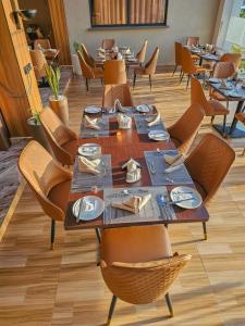 a dining room with a long table and chairs at Sebai Laxury Suit in Nairobi +14 photos