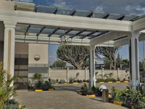 a white pergola in front of a building at Sebai Laxury Suit in Nairobi
