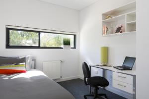 a bedroom with a bed and a desk at Western Sydney University Village - Campbelltown in Campbelltown