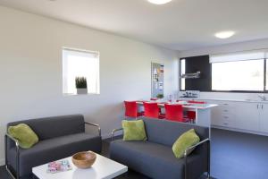 a living room with two chairs and a table at Western Sydney University Village - Campbelltown in Campbelltown