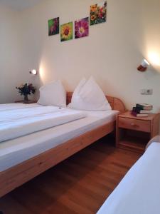 a bed in a room with two white beds at Ferienwohnung Ronacher in Abtenau