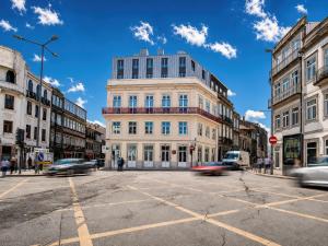 a building on the corner of a street with cars at Padrão 319 - Touristic Apartments in Porto