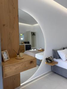 a bedroom with two beds and a mirror at Naxian Roots in Galini