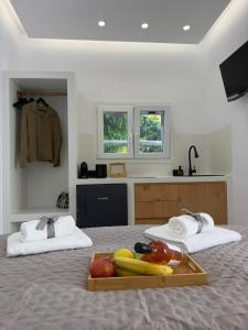 a bedroom with a tray of fruit on a bed at Naxian Roots in Galini