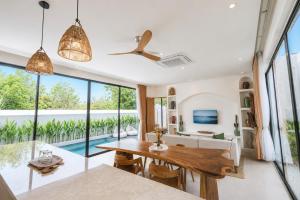 a dining room with a table and a view of the ocean at Santo Villa Uluwatu in Bingin Beach