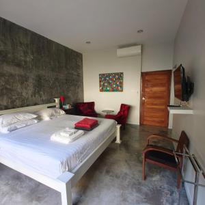 a bedroom with a bed and a chair and a television at Krabi Home and Beyond-Ao Nang in Ao Nang Beach +23 photos