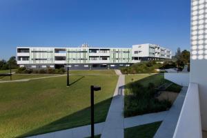 a view of a building with a park in front at Western Sydney University Village - Campbelltown in Campbelltown