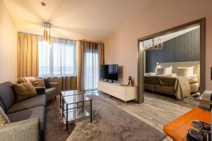 a living room with a couch and a bed and a mirror at Ikaalinen SPA & Resort in Ikaalinen