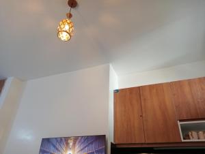 a room with a tv and a light on the ceiling at Tsavo in Nairobi +2 photos