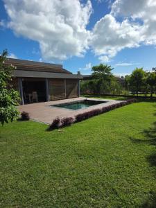 a backyard with a swimming pool and a house at Private Secured 4 Bedroom Villa in Grand-Baie
