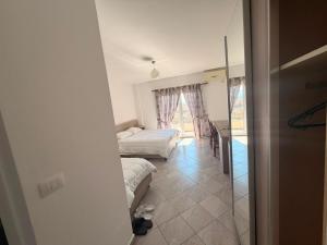 a small room with two beds and a kitchen at Hotel Klaivi in Lezhë +7 photos