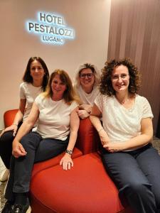 a group of women sitting on a couch at Hotel Pestalozzi Lugano in Lugano