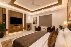 a hotel room with a bed and a flat screen tv at The Runway Corporate Hotel IGI Delhi Airport Terminal-3 With Free Airport Pickup in New Delhi