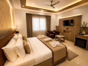 a hotel room with a bed and a television at The Runway Corporate Hotel IGI Delhi Airport Terminal-3 With Free Airport Pickup in New Delhi