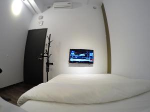 Tempat tidur dalam kamar di Lütel Hotel Xpark Gloria Outlets Shin Kong Cinemas