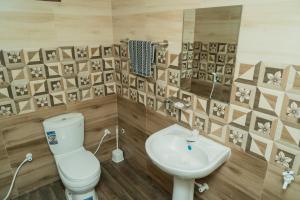 a bathroom with a toilet and a sink at Nilaveli Beach Bungalow in Trincomalee