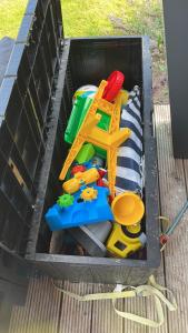 a black plastic bin filled with toys in it at Maristella 332 in Hindeloopen +21 photos