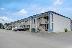 a large building with cars parked in a parking lot at Ole South Inn Jackson I 40 TN in Denmark