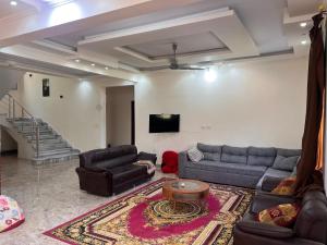 a living room with two couches and a tv at King mariout villa LA FIESTA in Borg El Arab