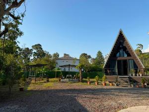 a house with a pointed roof and a playground at Cottage Lemons In Gonio in Batumi