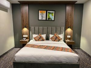 a bedroom with a large bed with two night stands at Destination Hotel Gilgit in Gilgit