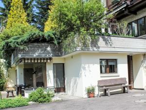 a building with a bench on the side of it at Apartment Ferienhüsli by Interhome in Siglistorf