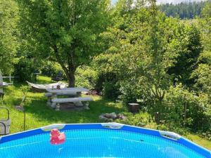 a swimming pool in a yard with a picnic table at Apartment Ferienhüsli by Interhome in Siglistorf