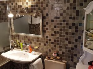 a bathroom with a sink and a mirror at Apartment Ferienhüsli by Interhome in Siglistorf +10 photos