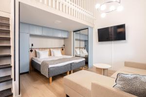 a bedroom with a bed and a couch at Ikaalinen SPA & Resort in Ikaalinen +27 photos