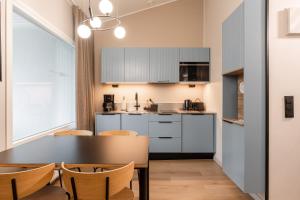 a kitchen with a table and chairs in a room at Ikaalinen SPA & Resort in Ikaalinen