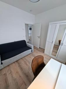 a living room with a couch and a table at Apartment Villa Brieselang in Brieselang
