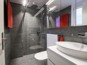 a bathroom with a sink and a toilet and a shower at Apartment Wohnung Wettstein by Interhome in Sörenberg +7 photos