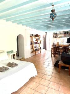 a bedroom with a bed and a dining room at Lilly's seaview Apartment in Mikonos