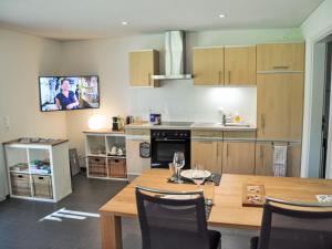 a kitchen with a wooden table and a dining room at Apartment Neuheim by Interhome in Neuheim