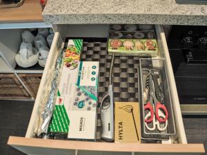 a drawer in a kitchen with a counter with items at Apartment Neuheim by Interhome in Neuheim +10 photos