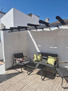 a patio with two chairs and a bench on a roof at Casa Branco in Borba