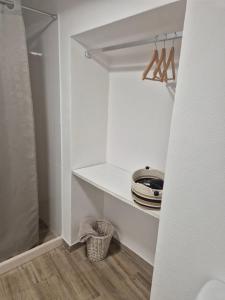 a walk in closet with white walls and wooden floors at Casa Branco in Borba +24 photos